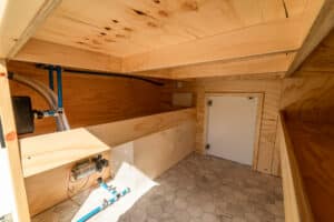 Interior with the bed box open, showing storage and water service area