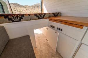 Storage bench and galley counter with cabinet doors open