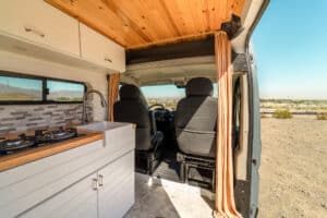 Galley counter and farm sink with the swivel seat and cab behind