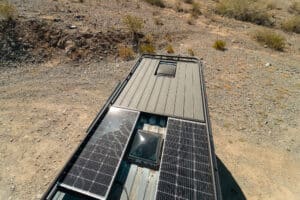 Roof of the Ram Promaster with 200W solar panels and decking on the roof rack