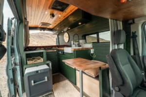 Interior from the sliding door with galley, table and swivel seat