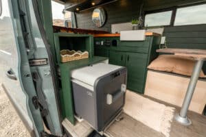 Pull-out Dometic fridge and storage bench by the sliding door