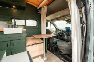 Galley, storage bench and table next to the swivel seat