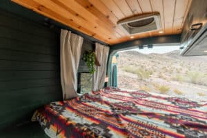 Bed and window with curtains under the wood ceiling