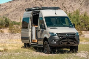 Front view of the Sprinter camper van showing the Backwoods bumper with push bar and roof rack
