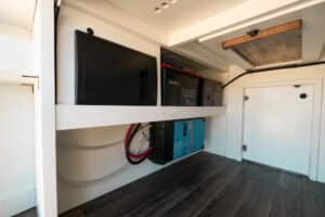 Electrical service area under the bed platform with batteries and wiring
