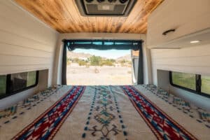 Bed seen from the cab with the rear doors open to the desert