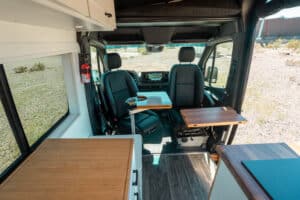 Cab seats swiveled toward the living area with teak countertop in front