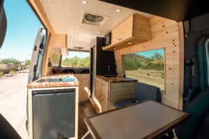 Maddox layout in a 2025 Mercedes Sprinter: pine interior, galley, fridge and table