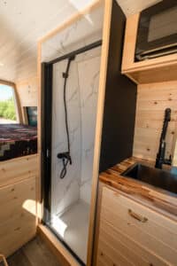 Heated indoor shower in the Maddox layout, next to the galley